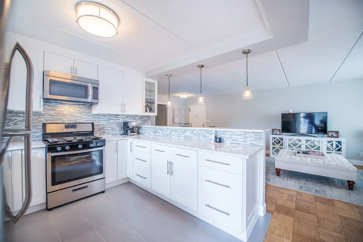 Peninsular with seating area and wine storage, white shaker cabinet in condo in Harrision NY