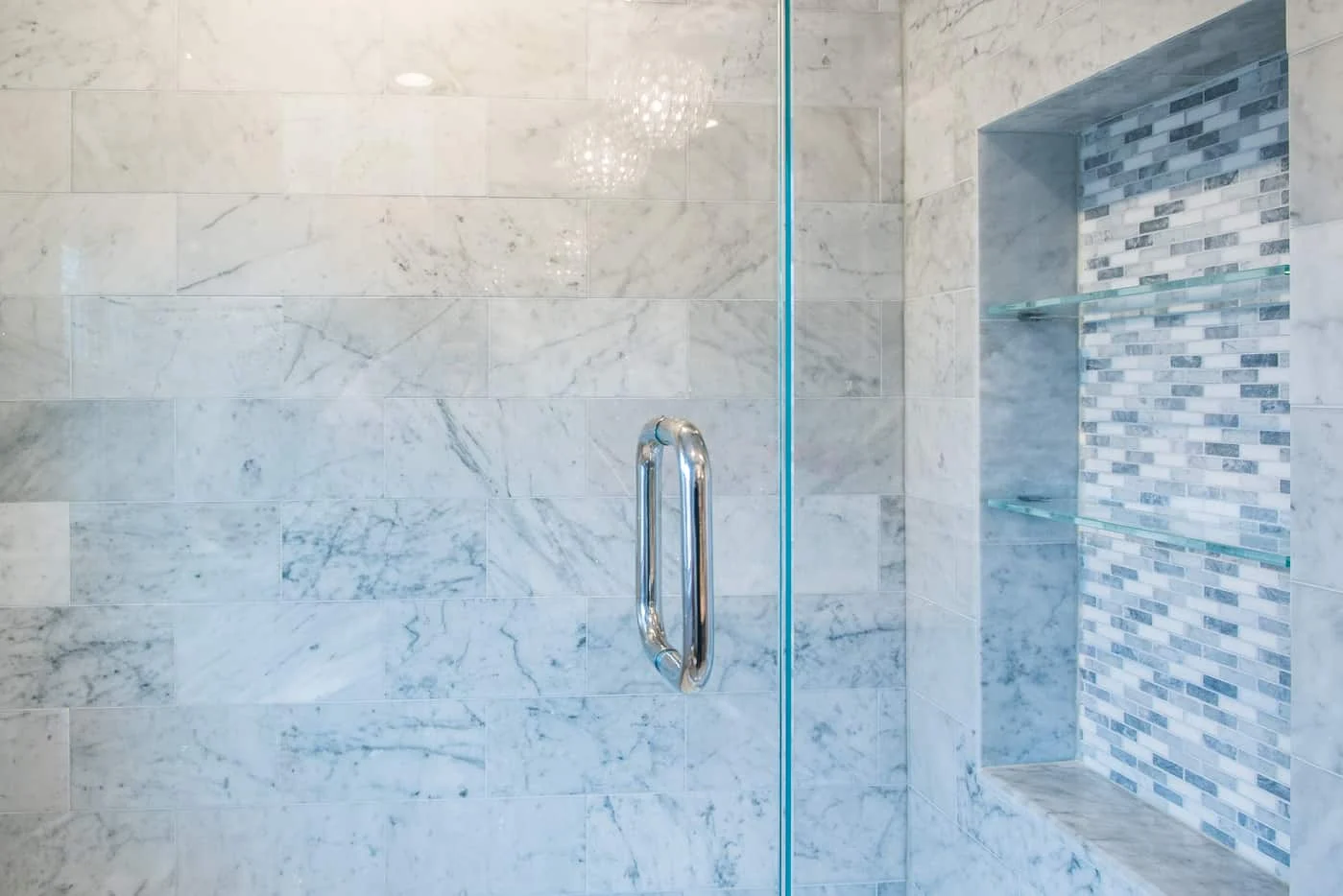 Shower niche with wall tiles and custom shower glass panel