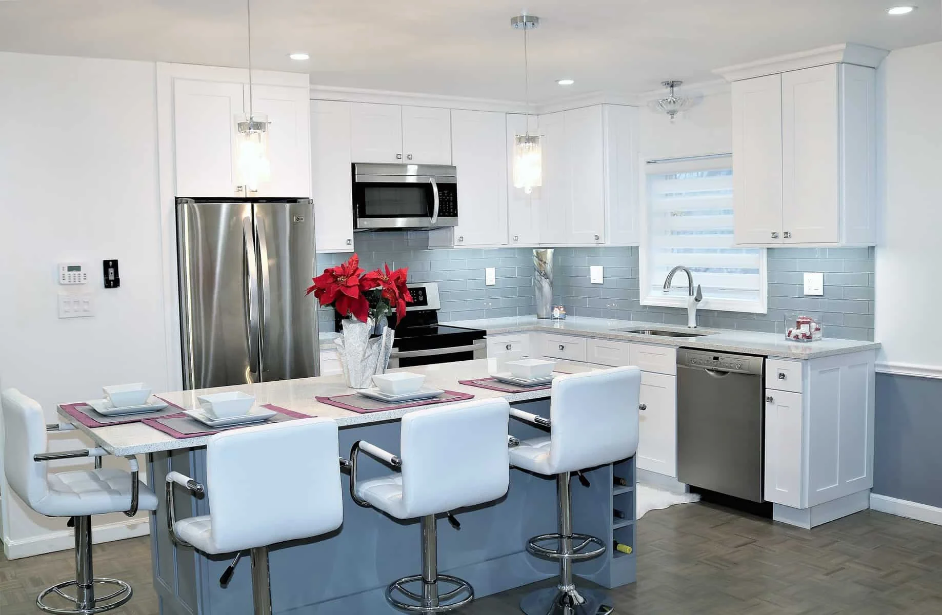condo kitchen with island grey island, White shaker perimeter cabinets