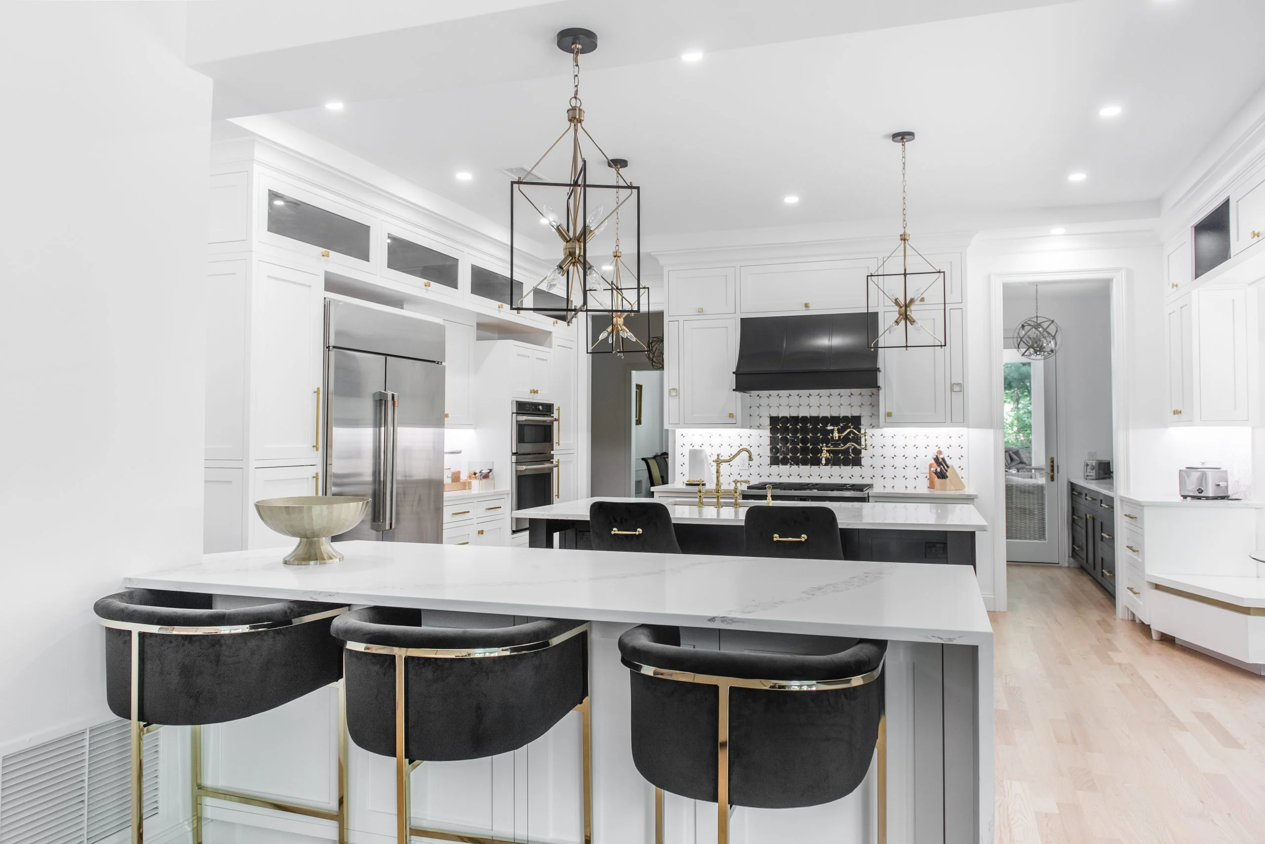 3 Island and Peninsular and full custom kitchen quartz countertop with waterfall edge with black and white cabinets in Rye NY