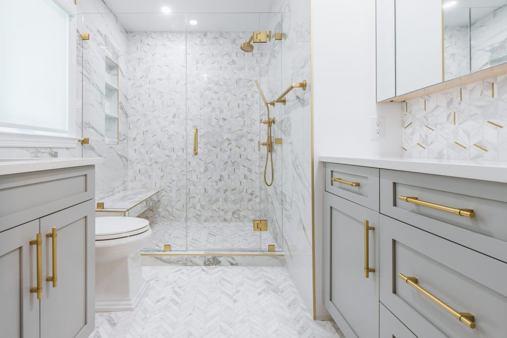 Marble tile with brass hardware bathroom remodel
