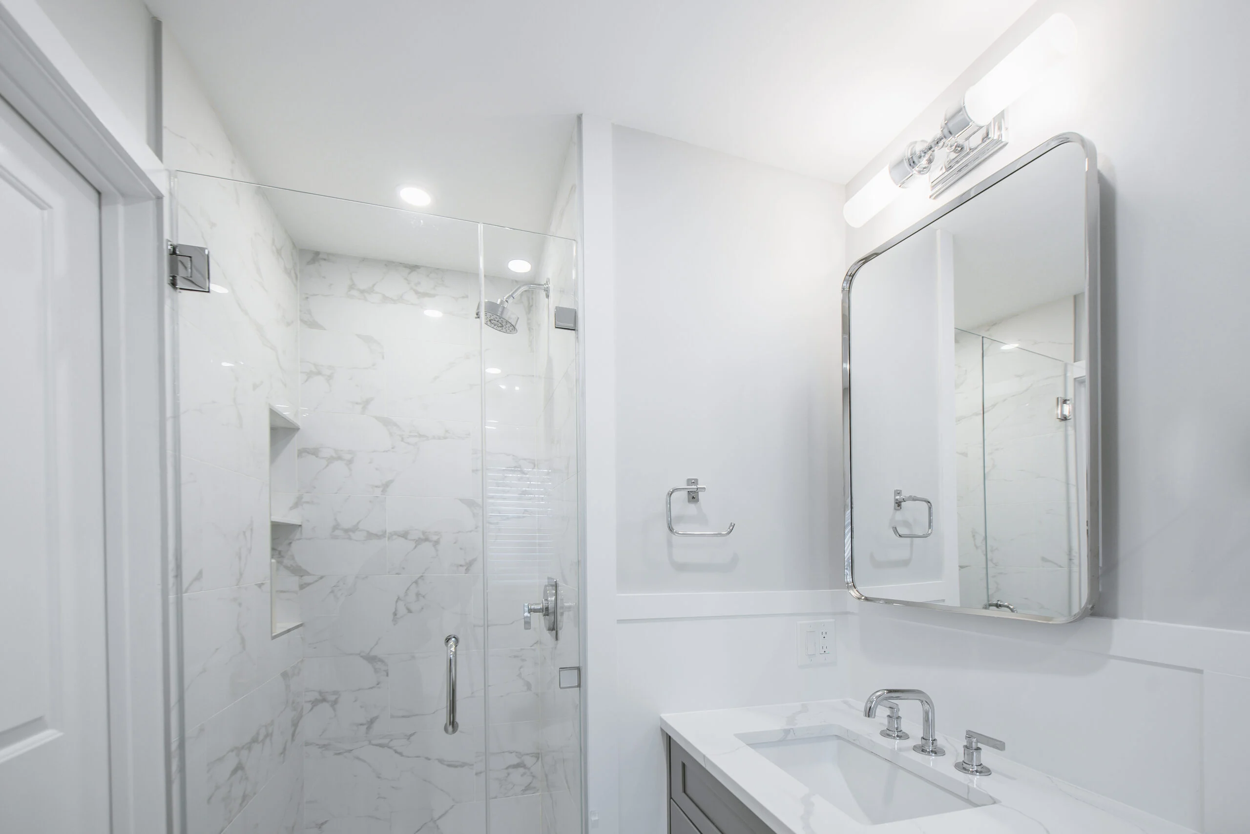 marble tile walk-in shower remodel with frameless glass door Scarsdale NY