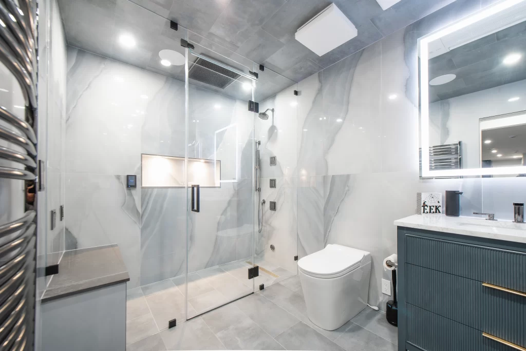Spa-style basement bathroom with steam shower and heated floors.