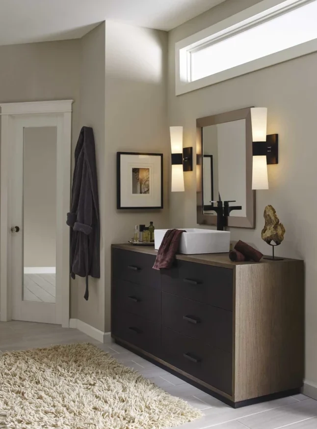 Vanity with matte-black and frosted-glass sconces